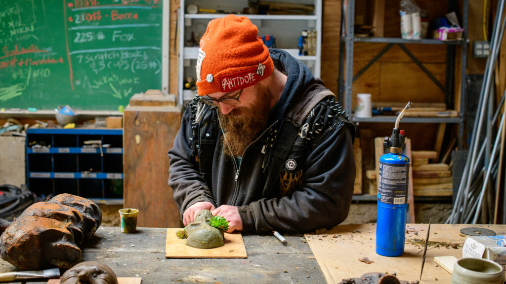 Student making an iron pour mold design